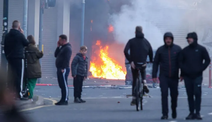 A building is set alight in the Sandy Row area of Belfast city centre, Northern Ireland, in the evening of June 9, 2026. Northern Ireland police appealed for calm Tuesday after a stabbing in Belfast allegedly by a Sudanese suspect and captured in a graphic video prompted calls for anti-immigration protests from UK far-right figures. (Photo by Paul Faith/AFP)