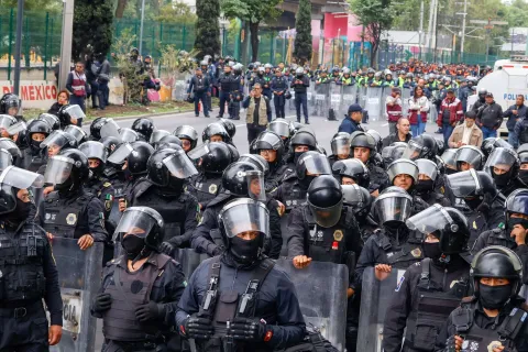 TOPSHOT - Members of the police block the way to the Ciudad de Mexico Stadium during a protest in Mexico City on June 9, 2026. Thousands of teachers blocked an avenue leading to the Azteca Stadium in Mexico City, 48 hours before the opening ceremony of the 2026 World Cup at that venue. (Photo by Gerardo Magallon/AFP)
