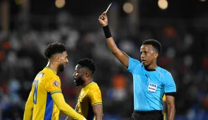 (FILES) Gabon's forward #20 Denis Bouanga is shown the yellow card by Somali referee Omar Abdulkadir Artan during the Africa Cup of Nations (CAN) Group F football match between Gabon and Ivory Coast at the Grand Stadium in Marrakech on December 31, 2025. Award-winning Somali referee Omar Artan, set to be the first from his country to officiate at the World Cup, was denied entry to the United States, a sports ministry official told AFP on June 8, 2026. "Denying him entry to the United States and preventing him from officiating scheduled matches harms not only him personally but also undermines football's commitment to fairness, merit, and the spirit of fair play," Ciise Aden Abshir, a senior advisor to Somalia's Ministry of Youth and Sports and a former national team captain, told AFP. (Photo by Khaled DESOUKI/AFP)