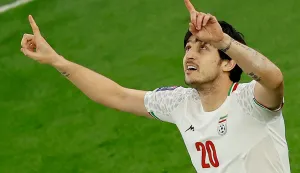 (FILES) Iran's forward #20 Sardar Azmoun celebrates after scoring his team's first goal during the Qatar 2023 AFC Asian Cup semi-final football match between Iran and Qatar at al-Thumama Stadium in Doha on February 7, 2024. Azmoun, the third-highest scorer in the history of the Iranian national team, is not among the players selected for the World Cup, according to a list published June 1, 2026, by the country's football federation. (Photo by KARIM JAAFAR/AFP)