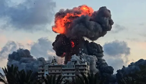 (FILES) A fireball and smoke erupt from a building following an Israeli strike in Tyre, southern Lebanon, on May 28, 2026. The world has settled in a high level of violence with, in 2025, the largest number of state conflicts since the end of World War II and an explosion of attacks directly targeting civilians, according to the annual PRIO Global Conflict Trends report on the trend of conflicts in the world published on June 9, 2026. (Photo by KAWANT HAJU/AFP)