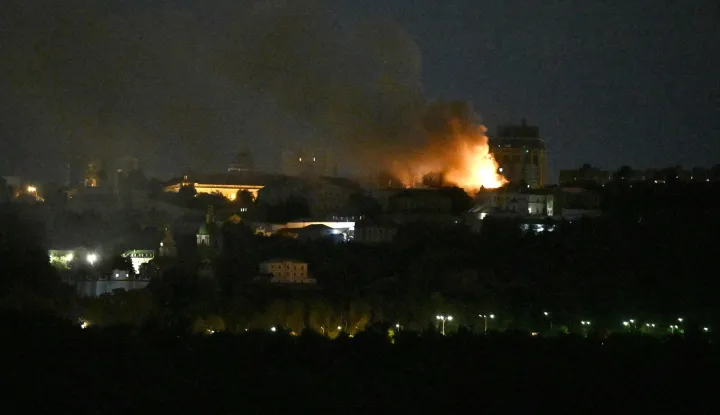 Smoke and fire is seen from the Dormition Cathedral in the Orthodox complex of the Kyiv Pechersk Lavra following a Russian missile strike on the Ukrainian capital Kyiv on June 15, 2026, amid the Russian invasion in Ukraine. A major missile attack struck Kyiv early on June 15, an AFP reporter witnessed, with projectiles intercepted in the sky and glowing debris falling onto the city. Ukrainian officials including the city's mayor Vitali Klitschko reported on Telegram that strikes hit various districts. (Photo by Genya Savilov/AFP)