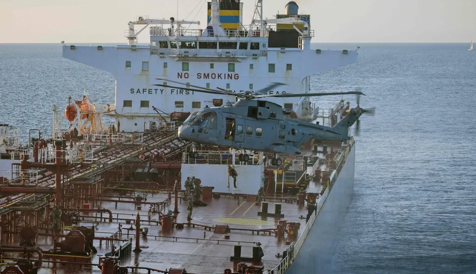 This handout picture taken on June 14, 2026 and released by the British Ministry of Defence (MOD) shows 42 Commando of the UK Commando force conducting maritime interdiction operations on the CMR Smyrtos sailing under a false Cameroonian flag, in the English Channel off the coast of the United Kingdom. British forces on June 14 intercepted a sanctioned oil tanker belonging to Russia's shadow fleet in the English Channel, the defence ministry said, in a six-hour operation hailed by Kyiv. (Photo by Ministry of Defence (United Kingdom)/AFP)/- NO Marketing campaign/-----EDITORS NOTE --- RESTRICTED TO EDITORIAL USE - MANDATORY CREDIT "AFP PHOTO/UK Ministry of Defence CROWN COPYRIGHT, 2026 " - NO MARKETING - NO ADVERTISING CAMPAIGNS - DISTRIBUTED AS A SERVICE TO CLIENTS - NO ARCHIVES - TO BE USED WITHIN 2 DAYS FROM JUNE 14, 2026 (48 HOURS), EXCEPT FOR MAGAZINES WHICH CAN PRINT THE PICTURE WHEN FIRST REPORTING ON THE EVENT/