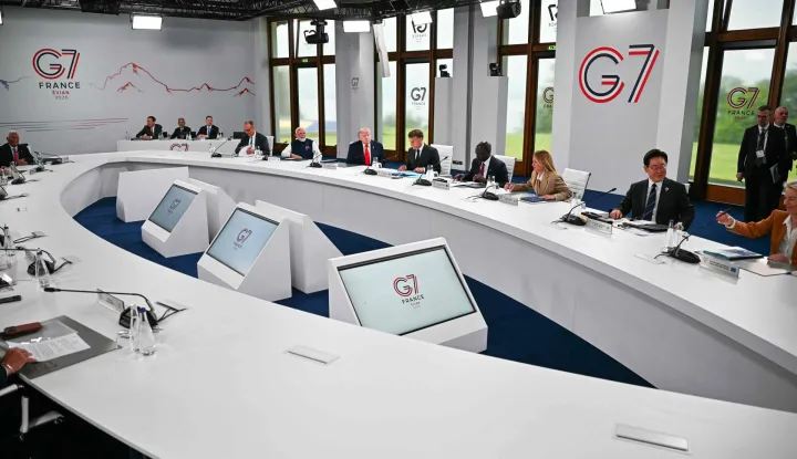 (From L) Germany?s Chancellor Friedrich Merz, India's Prime Minister Narendra Modi, US President Donald Trump, France's President Emmanuel Macron, Kenya's President William Ruto, Italy's Prime Minister Giorgia Meloni, South Korea's President Lee Jae-myung and European Commission President Ursula von der Leyen attend a work meeting as part of the G7 summit, in Evian, eastern France, on June 16, 2026. A G7 summit is set to take place June 15 to 17 in the French town of Evian-les-Bains near Switzerland and it will be attended by country leaders as well as the EU's foreign policy chief and ministers from Brazil, Canada, the United Arab Emirates and Turkey. (Photo by Mandel NGAN/AFP)