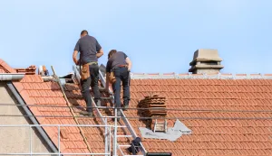 replacement of tile covering on the roof by two roofers