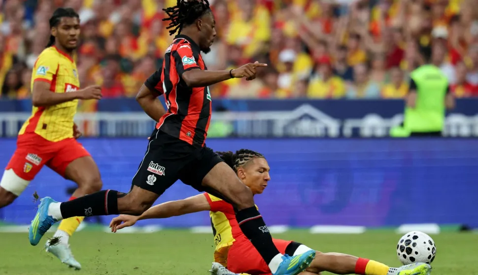 Nice?s French forward #11 Elye Wahi fights for the ball with Lens' French defender Pierre Ismaelo Ganiou during the French Cup final football match between RC Lens and OGC Nice at the Stade de France stadium, in Saint-Denis, on the outskirts of Paris, on May 22, 2026. (Photo by FRANCK FIFE/AFP)