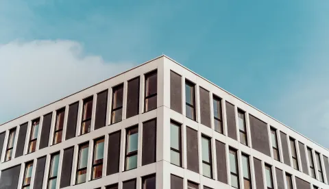 A low angle symmetric shot of old architecture with beautiful blue sky in the background