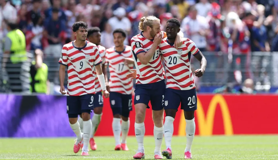 SEATTLE, WASHINGTON - JUNE 19: Players of the United States celebrate the team's first goal scored an own goal by Cameron Burgess #21 (not pictured) of Australia during the FIFA World Cup 2026 Group D match between USA and Australia at Seattle Stadium on June 19, 2026 in Seattle, Washington. Jamie Squire/Getty Images/AFP (Photo by JAMIE SQUIRE/GETTY IMAGES NORTH AMERICA/Getty Images via AFP)