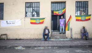 (FILES) A National Election Board of Ethiopia (NEBE) official stands at the entrance of a polling station in Kechene, Addis Ababa, on June 1, 2026 during the 2026 Ethiopian parliamentary elections. Ethiopian Prime Minister Abiy Ahmed's Prosperity Party (PP) won a landslide victory in legislative polls held June 1, the election commission said Sunday, giving it almost 90 percent of the seats.Abiy has led Ethiopia since 2018, and is increasingly criticised for growing authoritarianism, in contrast to his early years when he won the Nobel Peace Prize for mending relations with neighbouring Eritrea.The PP was considered the overwhelming favourite in the country of 130 million, facing a divided opposition that did not field candidates in many constituencies. (Photo by Marco Simoncelli/AFP)