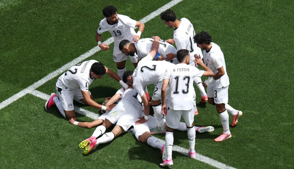 SEATTLE, WASHINGTON - JUNE 15: Emam Ashour #8 of Egypt celebrates with teammates after scoring the team's first goal during the FIFA World Cup 2026 Group G match between Belgium and Egypt at Seattle Stadium on June 15, 2026 in Seattle, Washington. Emilee Chinn/Getty Images/AFP (Photo by Emilee Chinn/GETTY IMAGES NORTH AMERICA/Getty Images via AFP)