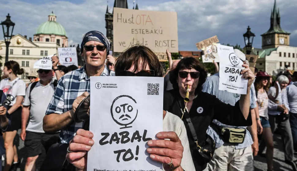 A protester holds a sign reading 'Just give up Czech Minister of Culture Oto Klempir' during a demonstration supporting public service media on May 24, 2026, in Prague, Czech Republic. A draft bill, which includes abolishing TV and radio license fees and has been criticized by the opposition and some experts would shift funding for CT (Czech Television) and CRo (Czech Radio) from license fees to the state budget. (Photo by Michal Cizek/AFP)