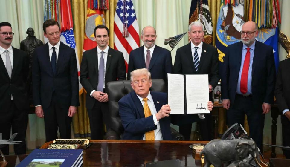 US Secretary of Commerce Howard Lutnick (3R), US Secretary of Energy Chris Wright (2R), Director of the Office of Management and Budget Russell Vought (R) look on as US President Donald Trump holds an executive order about quantumcomputing he just signed in the Oval Office of the White House in Washington, DC, on June 22, 2026. (Photo by Mandel NGAN/AFP)