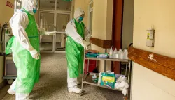 Two nurses in their Personal Protection Equipment (PPE) prepare to receive a patient with a highly infectious disease such as Ebola, during a simulation exercise at the special isolation ward of the department of Infectious Diseases Unit (IDU) at the the Kenyatta National hospital in Nairobi on June 12, 2026. (Photo by SIMON MAINA/AFP)