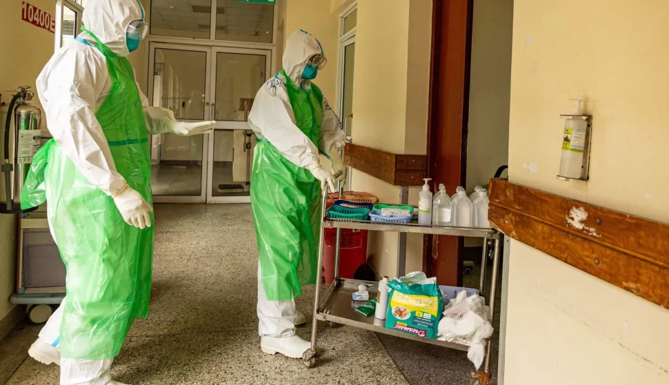 Two nurses in their Personal Protection Equipment (PPE) prepare to receive a patient with a highly infectious disease such as Ebola, during a simulation exercise at the special isolation ward of the department of Infectious Diseases Unit (IDU) at the the Kenyatta National hospital in Nairobi on June 12, 2026. (Photo by SIMON MAINA/AFP)