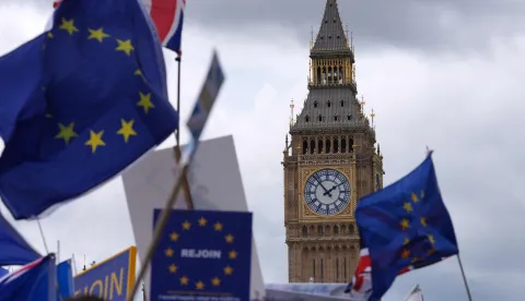 EU flags are waved beside The Elizabeth Tower commonly known by the name of the clock's bell "Big Ben, "during a National 'Rejoin the EU' march in central London on June 20, 2026. (Photo by CARLOS JASSO/AFP)
