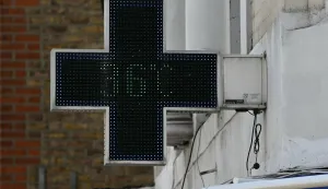 A sign outside a pharmacy displays the 36 degree temperature in west London during a heatwave, in central London on June 24, 2026. The UK recorded its hottest ever June temperature on Wednesday with the mercury rising to 35.7C south of London, breaking the previous record of 35.6C set in 1976. The UK's Met Office weather service said the temperature was recorded in Charlwood, near Gatwick Airport, as Britain experiences a second month in a row of record-breaking heat. (Photo by JUSTIN TALLIS/AFP)