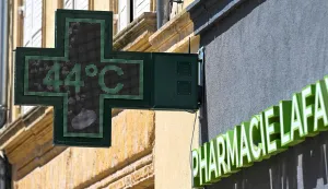 This photograph shows a pharmacy sign displaying the temperature of 44 degrees Celsius in Thionville, north-eastern France, on June 26, 2026, as a heatwave hits France. (Photo by Jean-Christophe Verhaegen/AFP)