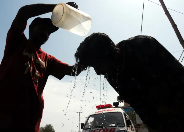 epa11488033 A man tries to cool off by getting water poured on his head at a roadside camp set up by the Edhi Foundation, as the heat wave continues in Karachi, Pakistan, 19 July 2024. The heatwave in Karachi has led to the hospitalization of 1,592 individuals at Jinnah Hospital within the past 24 hours, resulting in 49 fatalities, including 29 brought in dead, according to doctors. The city, currently experiencing extreme heat due to the suspension of sea breeze with temperatures soaring to a record 42 degree Celsius. Residents are advised to avoid sun exposure between 10am and 4pm. EPA/REHAN KHAN
