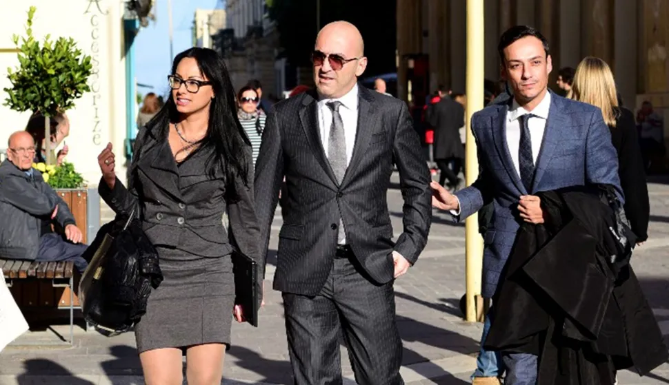 (FILES) Maltese tycoon Yorgen Fenech (C), whose business interests span the energy and tourism sectors, walks into court escorted by his lawyer Gianluca Caruana Curran (R) on November 29, 2019 in Valletta, Malta. The man accused of ordering the 2017 murder of a hard-hitting investigative journalist in Malta finally faced a court on July 1, 2026, marking a key moment in the criminal case that rocked the tiny nation. Businessman Yorgen Fenech is charged with orchestrating the assasination of Daphne Caruana Galizia, 53, a prominent public figure and vocal critic who was killed by a bomb placed in her car near her home. (Photo by AFP)