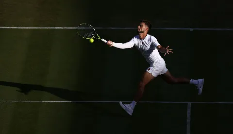 Croatia's Dino Prizmic returns to Canada's Felix Auger-Aliassime during their men's singles second round tennis match on the third day of the 2026 Wimbledon Championships at The All England Lawn Tennis and Croquet Club in Wimbledon, southwest London, on July 1, 2026. (Photo by Henry NICHOLLS/AFP)/RESTRICTED TO EDITORIAL USE