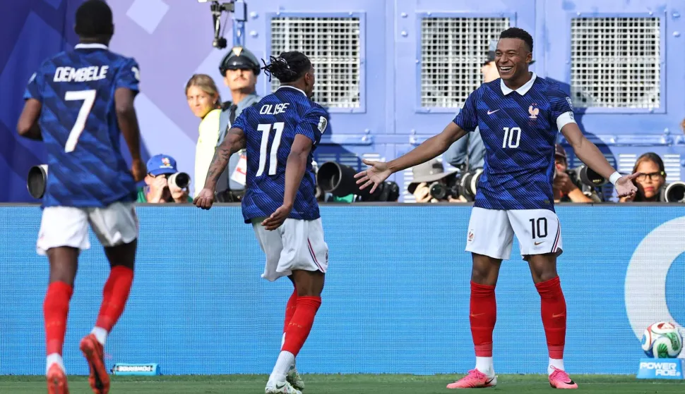 EAST RUTHERFORD, NEW JERSEY - JUNE 30: Kylian Mbappe #10 of France celebrates with teammate Michael Olise #11 after scoring his team's third goal during the FIFA World Cup 2026 Round Of 32 match between France and Sweden at New York New Jersey Stadium on June 30, 2026 in East Rutherford, New Jersey. Buda Mendes/Getty Images/AFP (Photo by Buda Mendes/GETTY IMAGES NORTH AMERICA/Getty Images via AFP)