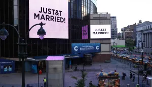 Giant screens showing the message "JUST&T MARRIED!" (T&T for Taylor and Travis) are seen outside Madison Square Garden, the reported venue for the wedding celebrations of pop singer Taylor Swift and pro-athlete Travis Kelce, in New York City on July 3, 2026. Swift and Kelce's official wedding plans are tightly under wraps, but New York is bracing to host the celebrity marriage of the year this week at Madison Square Garden. The wedding will reportedly take place Friday with a star-studded guest list of around 1,000, including models Gigi Hadid and Cara Delevingne, singer Selena Gomez, and actress Zoe Kravitz -- all known to be close Swift pals -- and Kelce's Kansas City Chiefs teammates. (Photo by CHARLY TRIBALLEAU/AFP)