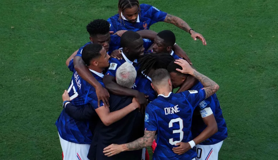 France's forward #10 Kylian Mbappe celebrates scoring his team's first goal with teammates and head coach Didier Deschamps during the 2026 World Cup round of 32 football match between France and Sweden at the New York/New Jersey Stadium in East Rutherford on June 30, 2026. (Photo by TIMOTHY A. CLARY/AFP)