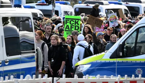 Demonstrators march towards the Messe Erfurt fairground in Erfurt, eastern Germany on early July 4, 2026, where the party congress of far-right Alternative for Germany (AfD) will be held. German police are bracing to guard an annual congress of the far-right AfD party this weekend against tens of thousands of antifascist demonstrators who are determined to shut it down. The standoff in the city of Erfurt, Thuringia state, comes as the opposition Alternative for Germany party is soaring in national opinion polls ahead of all other parties. (Photo by RALF HIRSCHBERGER/AFP)