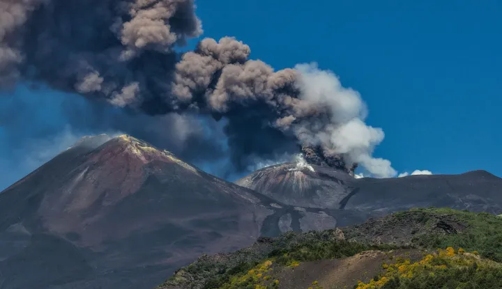 A photograph taken on July 5, 2026 shows smoke rising from the crater during an eruption of the Mount Etna volcano in Sicily. (Photo by Etna Walk/AFP)