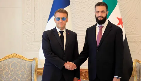 France's President Emmanuel Macron (L) shakes hands with Syrian President Ahmed al-Sharaa ahead of their meeting at the People's Palace in Damascus on July 7, 2026. French President Emmanuel Macron arrived in Damascus on July 6, 2026 for the first visit by a Western European head of state since Syria's new authorities took power in 2024, an AFP journalist said. Macron, who will depart on July 7, 2026, will advocate for "a free, pluralist Syria that respects each of its components" and plays a role in moderating Middle East tensions, the French presidency told journalists ahead of his arrival. (Photo by Ludovic MARIN/POOL/AFP)