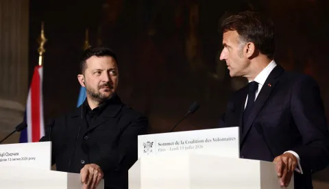 France's President Emmanuel Macron (R) and Ukraine's President Volodymyr Zelensky (L) address a press conference after the summit of the Coalition of the Willing to support Ukraine at the Hotel des Invalides in Paris on July 13, 2026. The summit meeting of the Coalition of the Willing -- launched by France and the United Kingdom to provide military support to Ukraine after Russia's full-scale invasion -- will push for a ceasefire and renewed peace talks, the French presidency said. (Photo by Teresa SUAREZ/POOL/AFP)