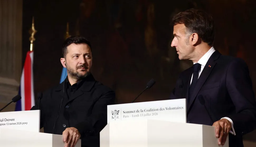 France's President Emmanuel Macron (R) and Ukraine's President Volodymyr Zelensky (L) address a press conference after the summit of the Coalition of the Willing to support Ukraine at the Hotel des Invalides in Paris on July 13, 2026. The summit meeting of the Coalition of the Willing -- launched by France and the United Kingdom to provide military support to Ukraine after Russia's full-scale invasion -- will push for a ceasefire and renewed peace talks, the French presidency said. (Photo by Teresa SUAREZ/POOL/AFP)
