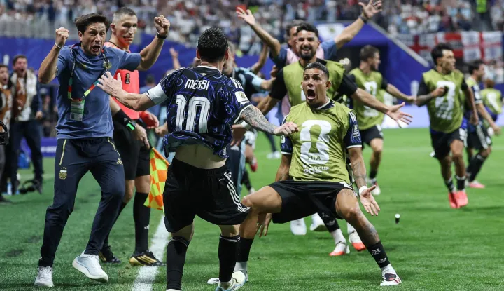 Argentina's forward #10 Lionel Messi celebrates with teammate defender #25 Facundo Medina his team's second goal scored by Argentina's forward #22 Lautaro Martinez (out of frame) during the 2026 World Cup football tournament semi-final match between England and Argentina at the Atlanta Stadium in Atlanta on July 15, 2026. (Photo by Thomas COEX/AFP)