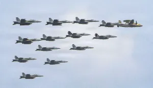 This US Navy handout photo released on July 15, 2026 and taken on June 30 by US Central Command Public Affairs shows fixed wing aircraft flying over Arleigh Burke-class guided-missile destroyer USS Frank E. Petersen Jr. (DDG 121) during a photo exercise. The US launched a wave of strikes against Iran on July 15, after it reimposed a naval blockade in a return to war between the two foes. Nearly a month after they signed a memorandum of understanding towards ending the Middle East war, the two sides resumed fighting with strikes on targets across the region. (Photo by US NAVY/AFP)/RESTRICTED TO EDITORIAL USE - MANDATORY CREDIT "AFP PHOTO/US NAVY/NAVCENT PUBLIC AFFAIRS" - HANDOUT - NO MARKETING NO ADVERTISING CAMPAIGNS - DISTRIBUTED AS A SERVICE TO CLIENTS