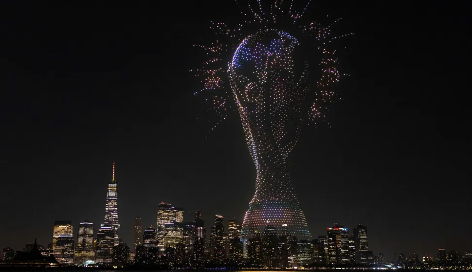 JERSEY CITY, NEW JERSEY - JULY 17: A general view as a drone show takes place over the New York Harbour, displaying a graphic of the FIFA World Cup trophy, in front of the Lower Manhatten skyline at Liberty State Park on July 17, 2026 in Jersey City, New Jersey. Justin Setterfield/Getty Images/AFP (Photo by Justin Setterfield/GETTY IMAGES NORTH AMERICA/Getty Images via AFP)