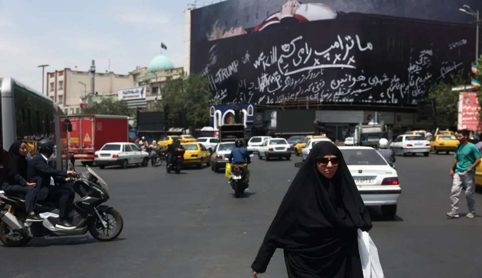 A woman walks next to a billboard depicting U.S. President Donald Trump laid in a coffin, in Tehran, Iran, July 18, 2026. Majid Asgaripour/WANA (West Asia News Agency) via REUTERS ATTENTION EDITORS - THIS PICTURE WAS PROVIDED BY A THIRD PARTY. ISRAEL OUT. NO COMMERCIAL OR EDITORIAL SALES IN ISRAEL. NO ACCESS FOR ISRAELI MEDIA. NO USE BBC PERSIAN. NO USE VOA PERSIAN. NO USE MANOTO. NO USE IRAN INTERNATIONAL. NO USE RADIO FARDA. DIGITAL: NO USE BBC PERSIAN. NO USE VOA PERSIAN. NO USE MANOTO. NO USE IRAN INTERNATIONAL. NO USE RADIO FARDA. ISRAEL OUT. NO COMMERCIAL OR EDITORIAL SALES IN ISRAEL Photo: MAJID ASGARIPOUR/REUTERS