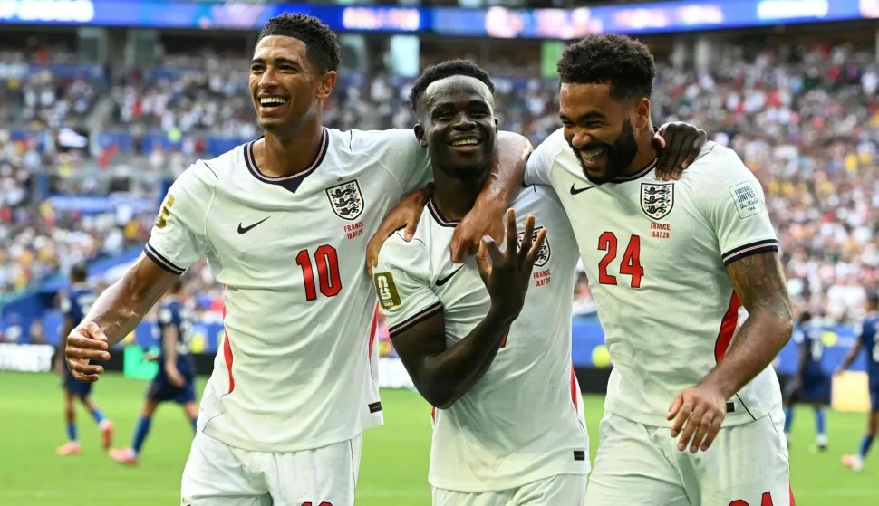 TOPSHOT - England's forward #07 Bukayo Saka (C) celebrates scoring his team's fifth goal with teammates midfielder #10 Jude Bellingham and defender #24 Reece James during the 2026 World Cup football tournament third-place match between France and England at the Miami Stadium in Miami on July 18, 2026. (Photo by ROBERTO SCHMIDT/AFP)