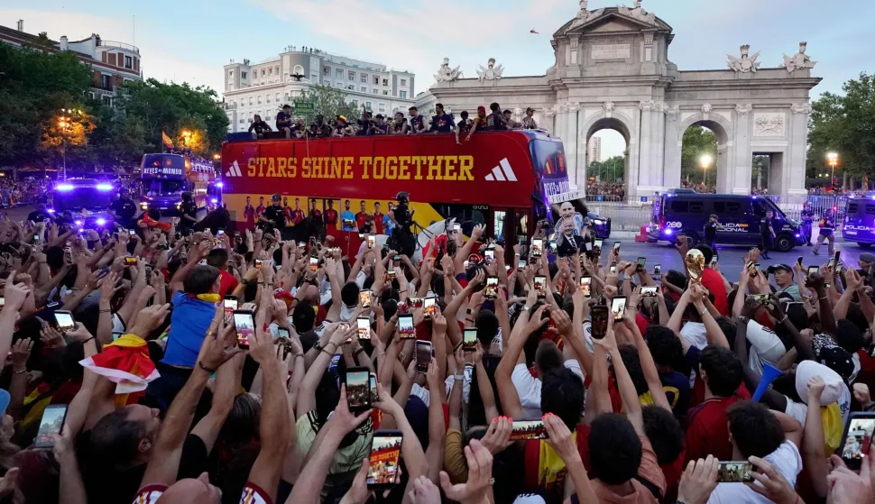 Spain's players parade onboard an open-top bus through the streets of Madrid on July 20, 2026, one day after the national football team won their second World Cup title following a 1-0 victory against Argentina. Spain's World Cup winners come back home to a heroes' welcome in Madrid, where a million fans are expected to greet them after a night of raucous celebrations across the country. (Photo by Paul Hanna/AFP)