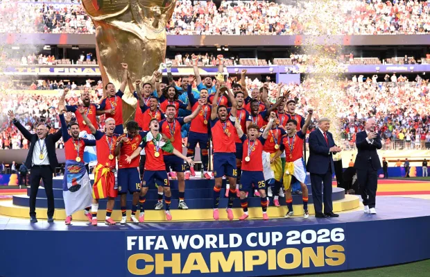 EAST RUTHERFORD, NEW JERSEY - JULY 19: Rodri #16 of Spain lifts the FIFA World Cup Winner?s Trophy alongside U.S. President Donald Trump and FIFA President Gianni Infantino after the team?s victory following during the FIFA World Cup 2026 Final match between Spain and Argentina at New York New Jersey Stadium on July 19, 2026 in East Rutherford, New Jersey. David Ramos/Getty Images/AFP (Photo by David Ramos/GETTY IMAGES NORTH AMERICA/Getty Images via AFP)