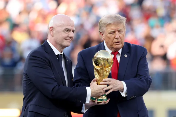 EAST RUTHERFORD, NEW JERSEY - JULY 19: U.S. President Donald Trump and FIFA President Gianni Infantino hold the FIFA World Cup Winner's Trophy before handing over to captain Rodri #16 of Spain at the award ceremony following the FIFA World Cup 2026 Final match between Spain and Argentina at New York New Jersey Stadium on July 19, 2026 in East Rutherford, New Jersey. Carl Recine/Getty Images/AFP (Photo by Carl Recine/GETTY IMAGES NORTH AMERICA/Getty Images via AFP)