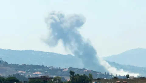 This photograph taken from the southern Lebanese city of Nabatieh shows smoke rising from the site of an Israeli controlled explosion in Kfar Tibnit village on July 21, 2026. The Lebanese army announced on July 21 that it had begun deploying to an area in the south, one of three "pilot zones" outlined in a deal with Israel to disarm Hezbollah. (Photo by Abbas Fakih/AFP)