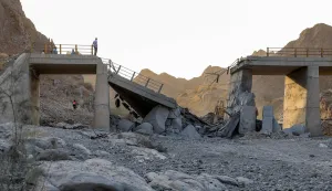 TOPSHOT - A heavily-damaged bridge which was hit by a US strike is pictured along the road connecting Roudan and Bandar Abbas in southern Iran on July 18, 2026. The United States hit Iran on July 17, with Tehran accusing US forces of striking civilians sites and drawing Iranian threats of reprisals on regional infrastructure. A battle over the strategic Strait of Hormuz has rekindled the war in the Middle East and the foes have traded fire for six days running. (Photo by Amir Hossein KHORGOOEI/ISNA/AFP)/