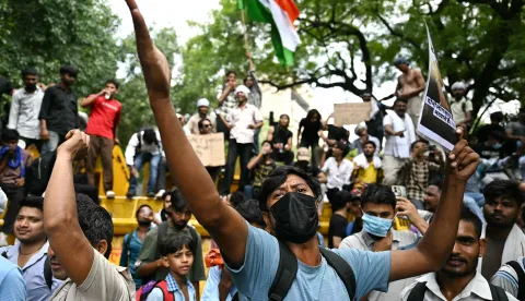 TOPSHOT - A Cockroach Janta Party (CJP) supporter shouts slogans at Jantar Mantar in New Delhi on July 23, 2026 during the ongoing protest to demand the resignation of India's Education Minister Dharmendra Pradhan over alleged NEET exam irregularities. Indian Prime Minister Narendra Modi on July 23 vowed "stringent punishment" for those involved in exam fraud that has fuelled student anger, in his first direct comments tied to major protests challenging his government. (Photo by Sajjad HUSSAIN/AFP)