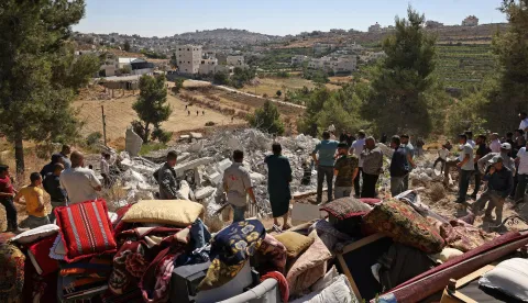 Local residents look for their belongings amid the rubble of Palestinian house that was demolished by Israeli security forces' as it was reportedly built without a permit in the village of Sa'ir, east of Hebron in the occupied West Bank, on July 21, 2026. Since the start of the Gaza war in October 2023, violence has escalated in the West Bank. (Photo by HAZEM BADER/AFP)