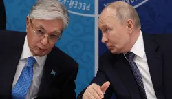 In this pool photograph distributed by the Russian state agency Sputnik, Russia's President Vladimir Putin (R) speaks to Kazakhstan's President Kassym-Jomart Tokayev as they attend the 22nd Russia-Kazakhstan Forum of Interregional Cooperation in Omsk on July 25, 2026. (Photo by Vyacheslav PROKOFYEV/POOL/AFP)