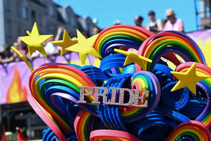 A drag queen wears a colourful headdress with the lettering 'Pride' prior to the start of the Christopher Street Day (CSD) parade in Berlin on July 25, 2026. This year's CSD parade takes place under the slogan 'Taking a stand is Hot', where various groups will demonstrate in support of diversity, human rights, and the protection of minorities. (Photo by RALF HIRSCHBERGER/AFP)