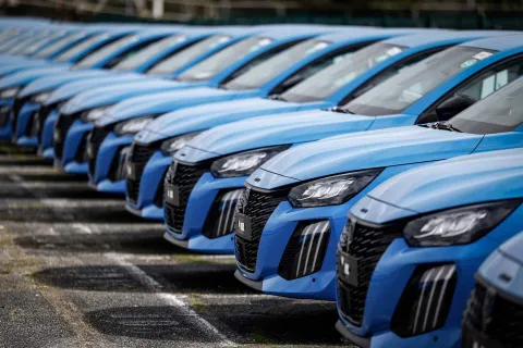 (FILES) Peugeot cars are seen parked outside the Stellantis multinational car manufacturer's plant in Poissy, west of Paris, on April 15, 2026. New car sales jumped 11.4% year-on-year in June, in a market that still has not returned to its pre-Covid-19 pandemic level, according to preliminary data released on July 1, 2026 by the Automotive Platform (PFA). (Photo by Simon Wohlfahrt/AFP)