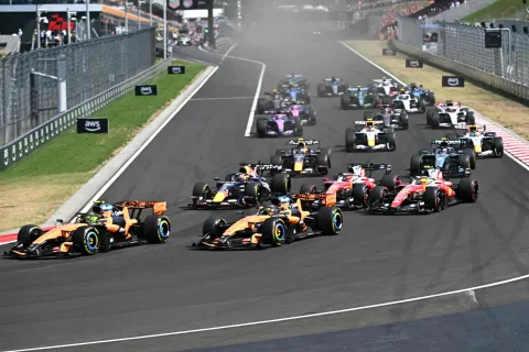 McLaren's British driver Lando Norris (L) followed by McLaren's Australian driver Oscar Piastri (3-L) and other cars compete during the Formula One Hungarian Grand Prix at the Hungaroring racetrack in Mogyorod near Budapest, Hungary, on July 26, 2026. (Photo by Attila KISBENEDEK/AFP)