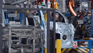 An employee works at the Ford factory in Almussafes, near Valencia on July 23, 2026. US automaker Ford announced today that it plans to create a joint venture with Chinese group Geely at its struggling Spanish plant in Valencia, which will produce four additional models for both companies. (Photo by JOSE JORDAN/AFP)
