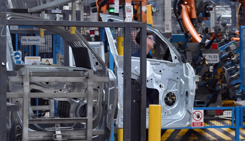 An employee works at the Ford factory in Almussafes, near Valencia on July 23, 2026. US automaker Ford announced today that it plans to create a joint venture with Chinese group Geely at its struggling Spanish plant in Valencia, which will produce four additional models for both companies. (Photo by JOSE JORDAN/AFP)